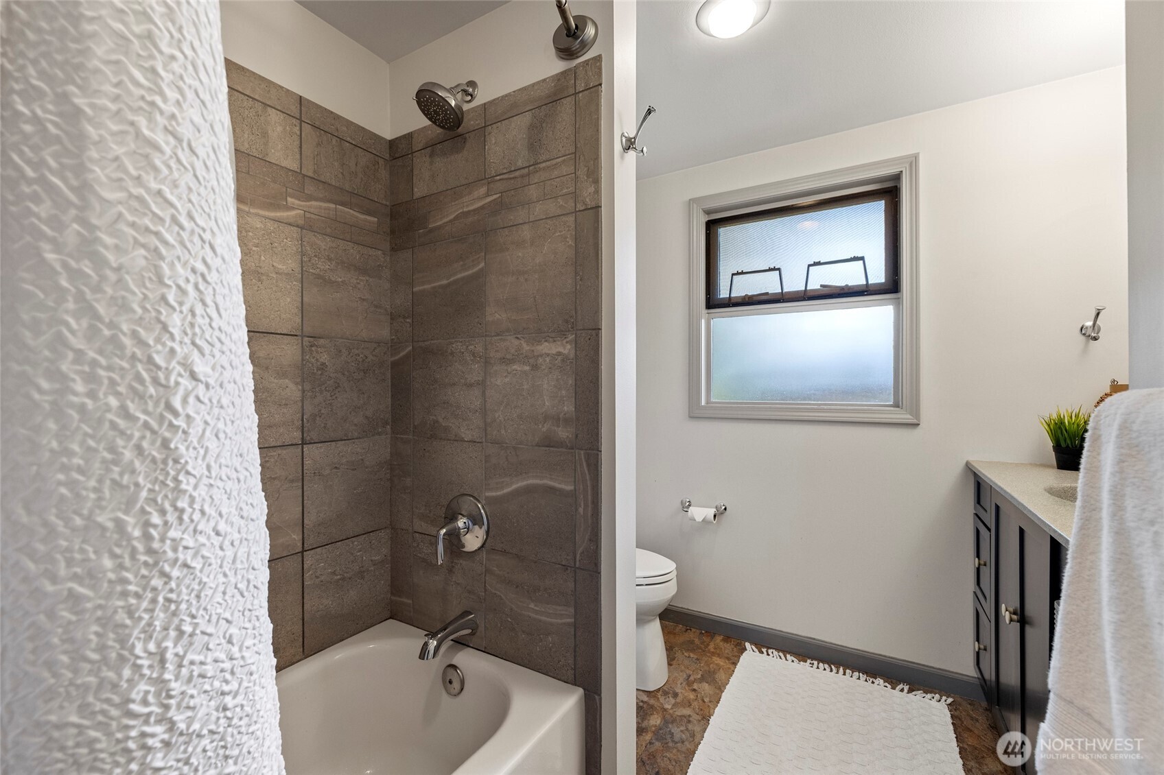 2408 148th Street Southwest Lynnwood, WA 98087 - Photo 16 of 40 a bathroom with a sink mirror vanity and toilet