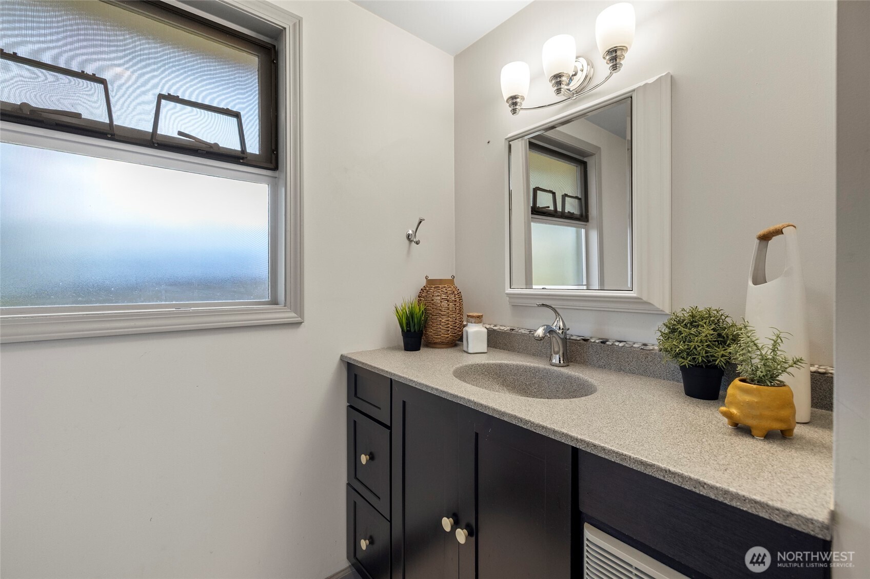 2408 148th Street Southwest Lynnwood, WA 98087 - Photo 17 of 40 a bathroom with a sink a potted plant and a mirror