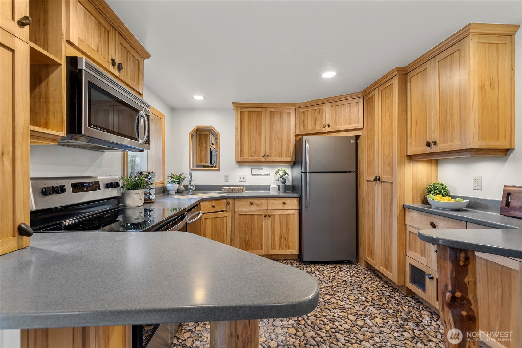 2408 148th Street Southwest Lynnwood, WA 98087 - Photo 4 of 40 a kitchen with stainless steel appliances granite countertop a refrigerator a stove top oven a sink and dishwasher