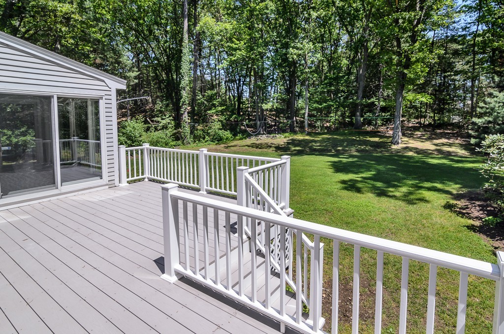 7 Folsoms Pond Road Wayland, MA 01778 - Photo 16 of 18 a view of a wooden deck and a yard with wooden fence