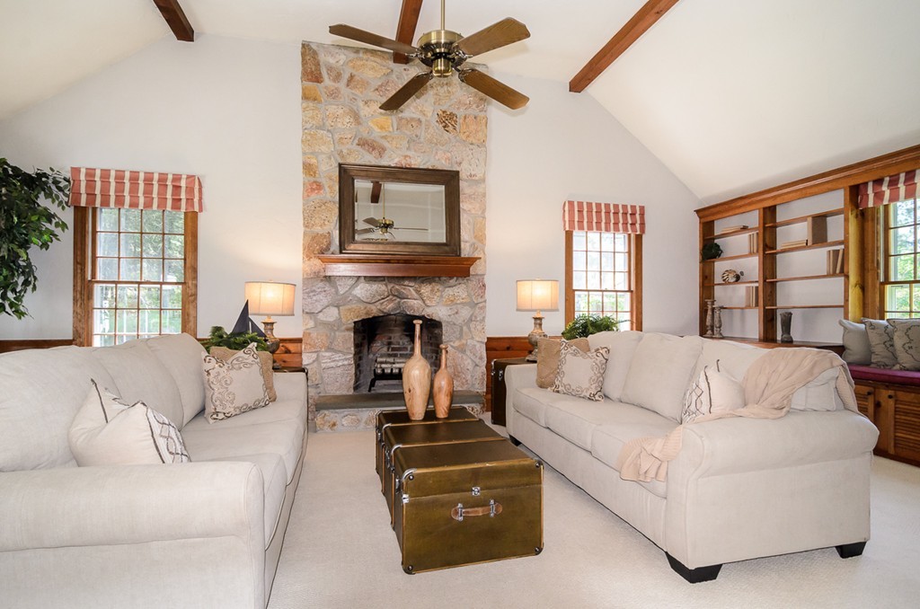 7 Folsoms Pond Road Wayland, MA 01778 - Photo 4 of 18 a living room with furniture a flat screen tv and a fireplace