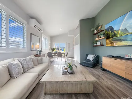 a living room with furniture and painting on the wall