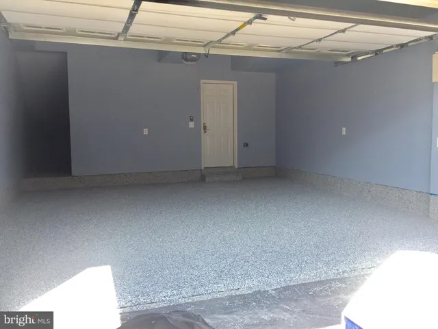 a kitchen with kitchen island white cabinets and stainless steel appliances