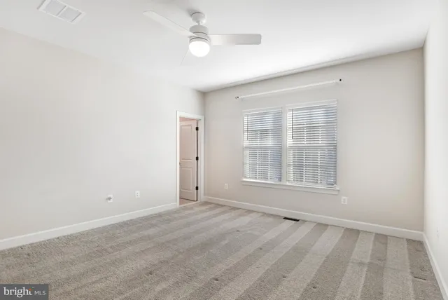 a bathroom with a sink a toilet a mirror and shower curtain