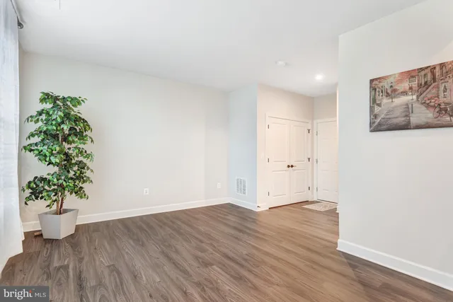 a kitchen with stainless steel appliances a stove top oven a sink a center island and cabinets