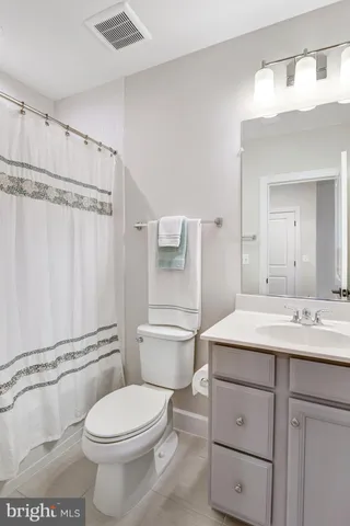 a kitchen with stainless steel appliances kitchen island granite countertop a stove a sink a dining table and chairs