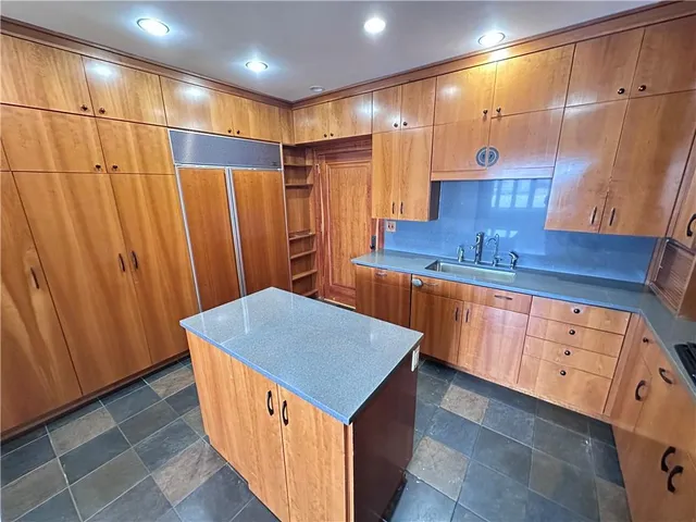 a kitchen with stainless steel appliances granite countertop a sink counter space and cabinets