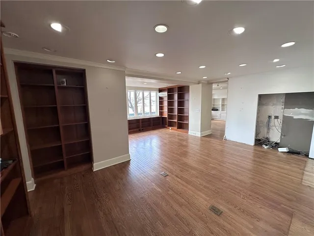 a view of a room with wooden floor and windows