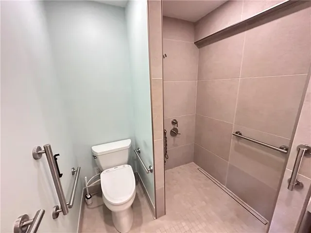 a white toilet sitting next to a bathroom sink