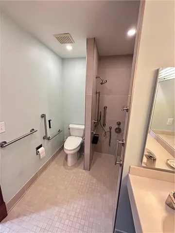 a bathroom with a sink toilet and shower