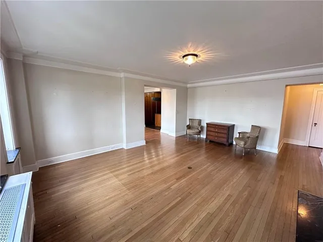 a furnished livingroom with windows and wooden floor