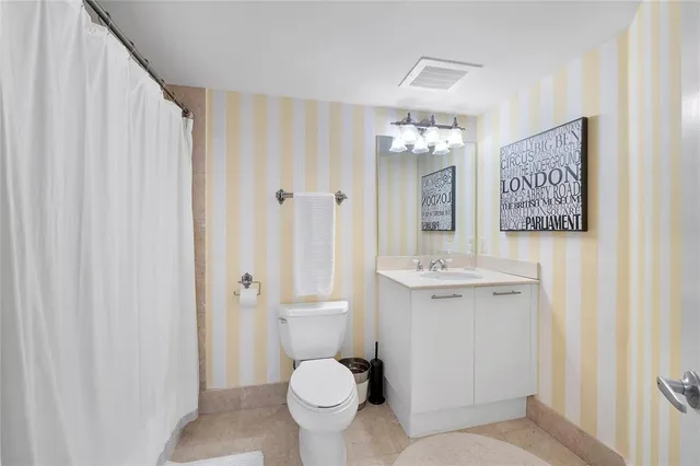 a bedroom with a bed cabinets and a window