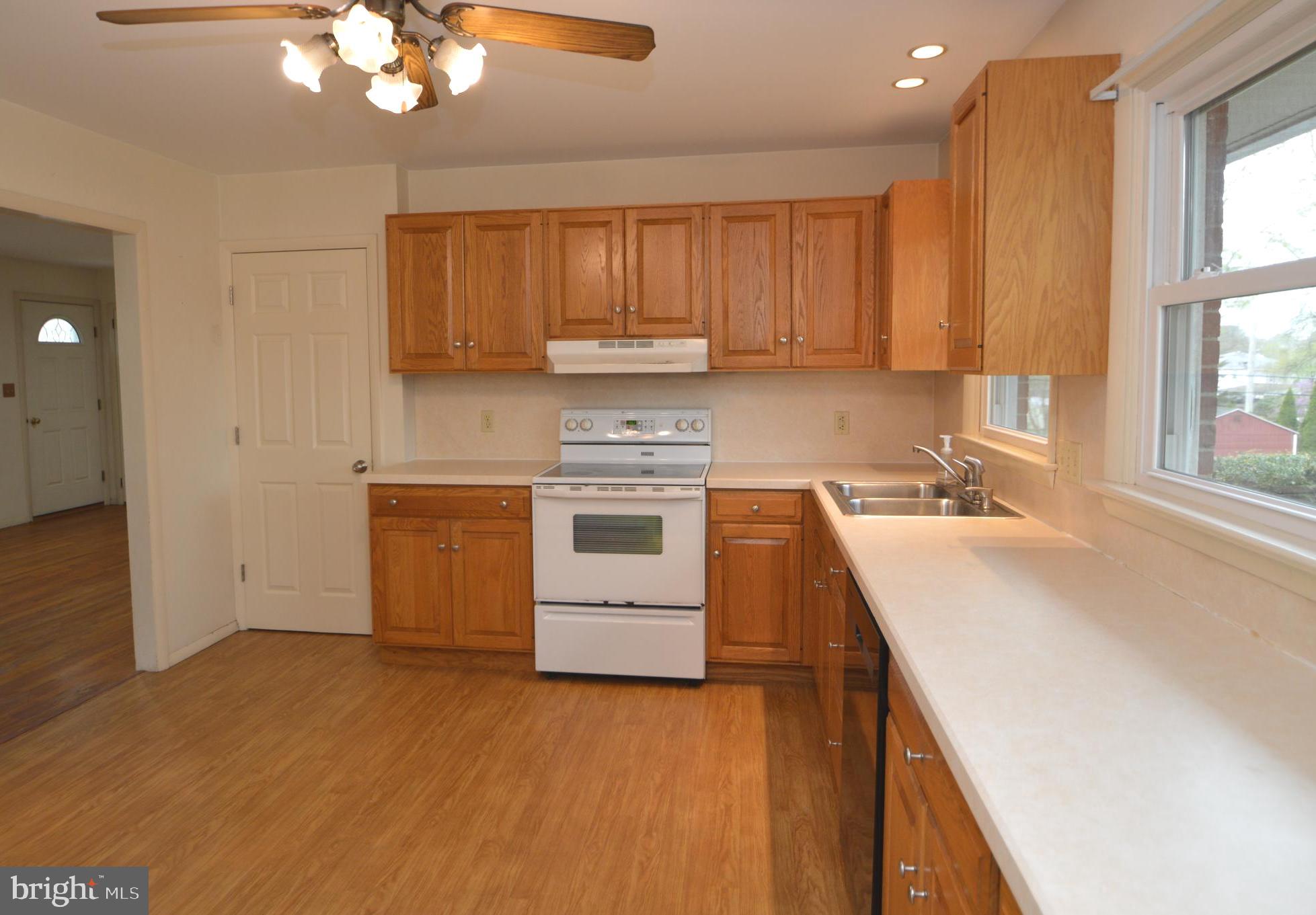 401 Lemon Street Elizabethtown, PA 17022 - Photo 15 of 39 a kitchen with a sink a stove cabinets and a wooden floor