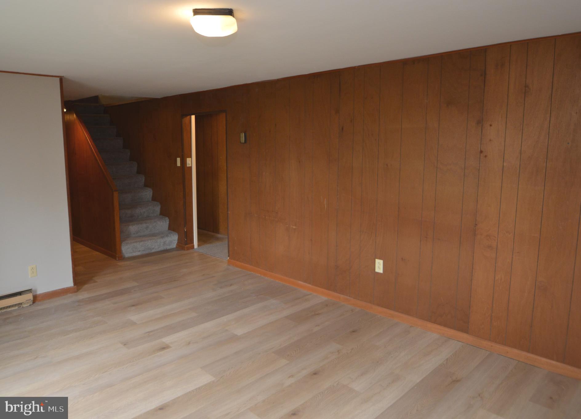 401 Lemon Street Elizabethtown, PA 17022 - Photo 26 of 39 a view of an empty room with wooden floor and stairs