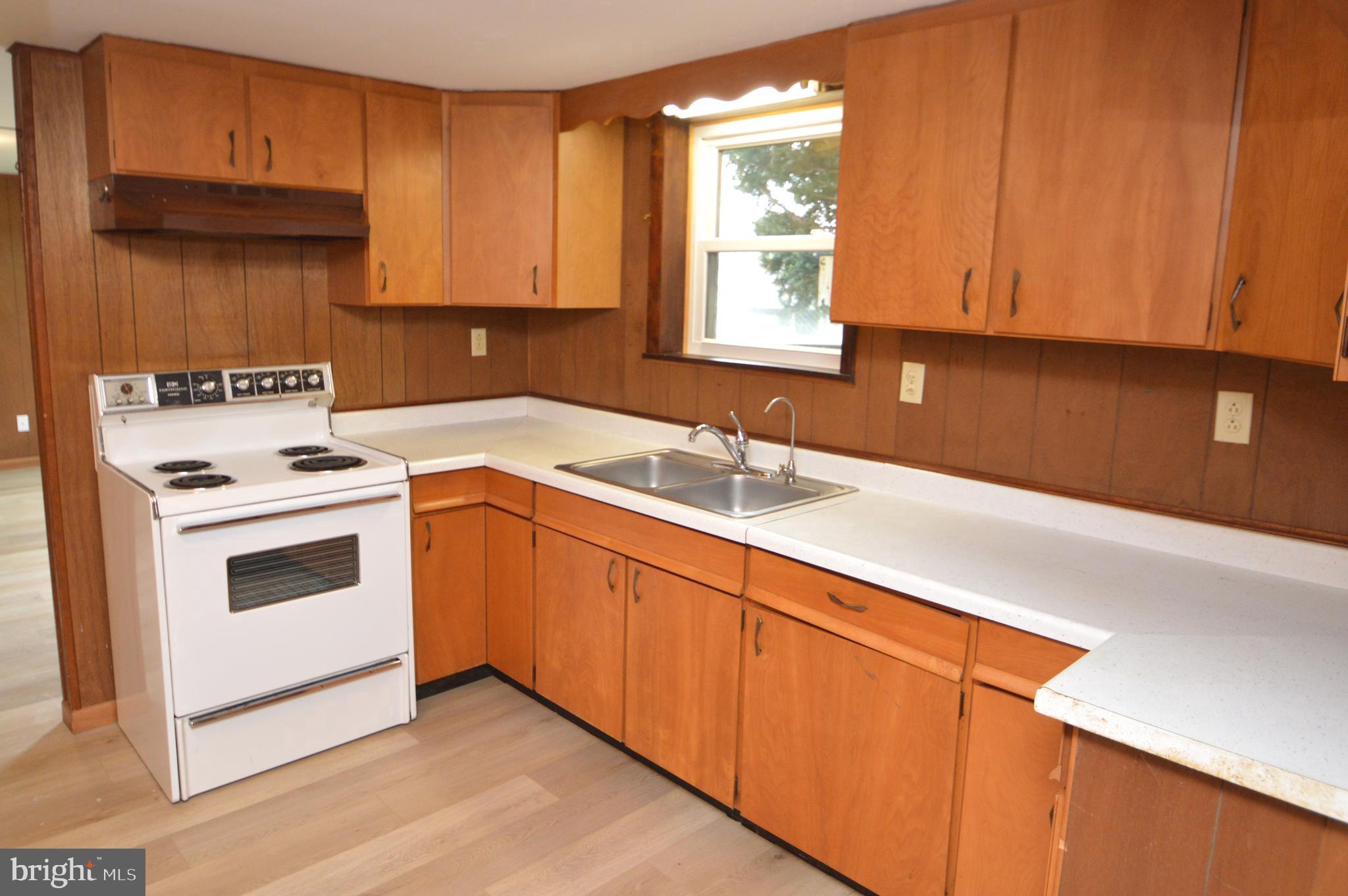 401 Lemon Street Elizabethtown, PA 17022 - Photo 28 of 39 a kitchen with granite countertop white cabinets sink and white appliances