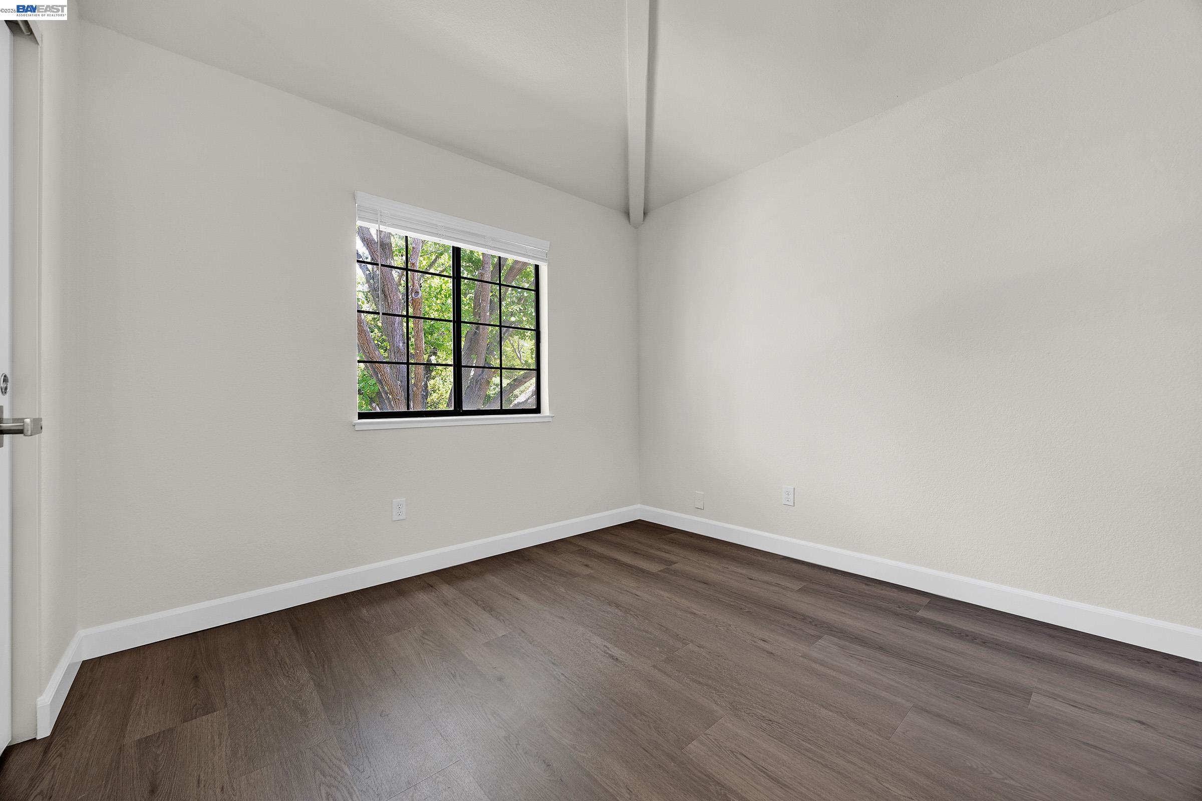 5012 Lakeview Drive, Unit 200 San Ramon, CA 94582 - Photo 21 of 47 an empty room with wooden floor and windows