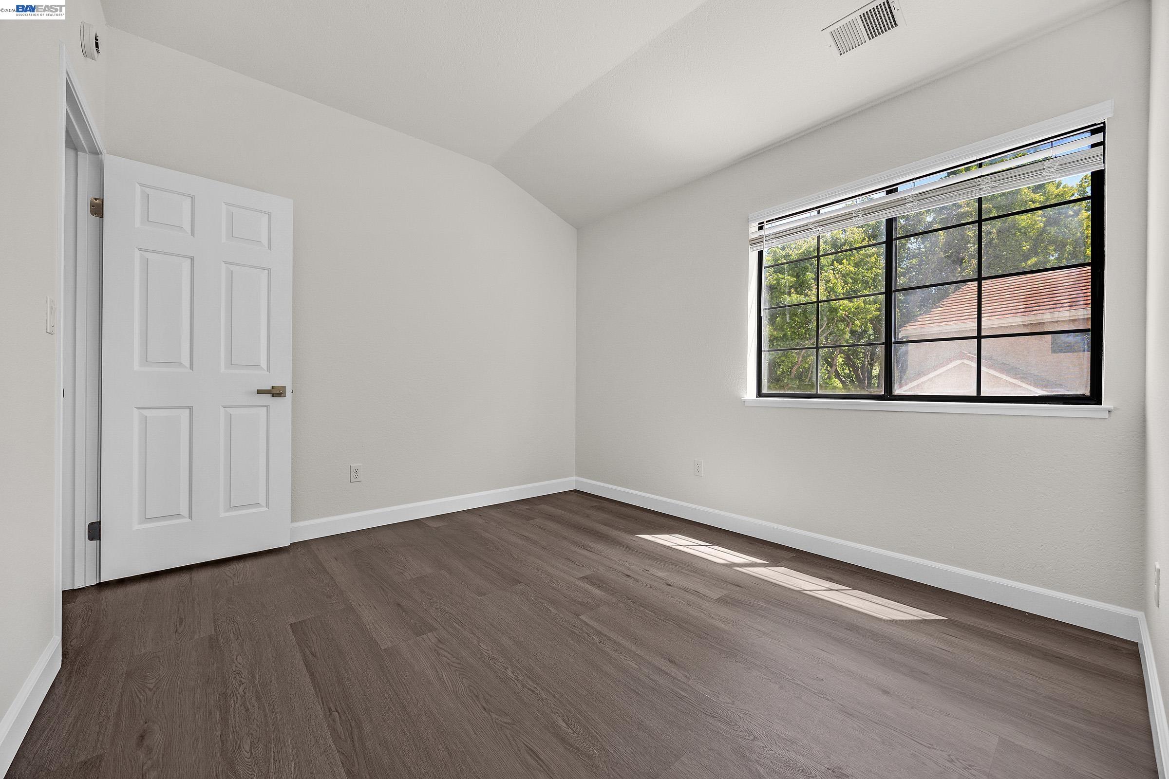 5012 Lakeview Drive, Unit 200 San Ramon, CA 94582 - Photo 23 of 47 an empty room with wooden floor and windows