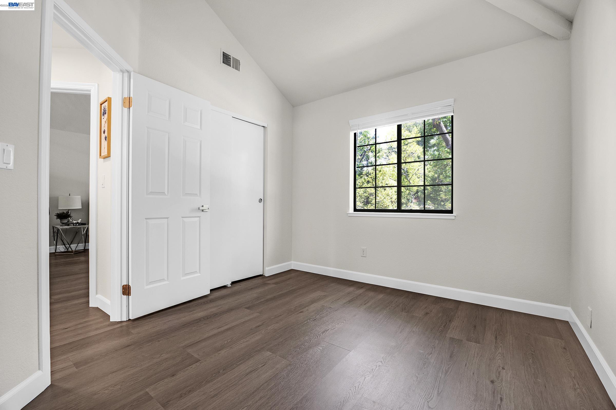 5012 Lakeview Drive, Unit 200 San Ramon, CA 94582 - Photo 24 of 47 an empty room with wooden floor closet and windows