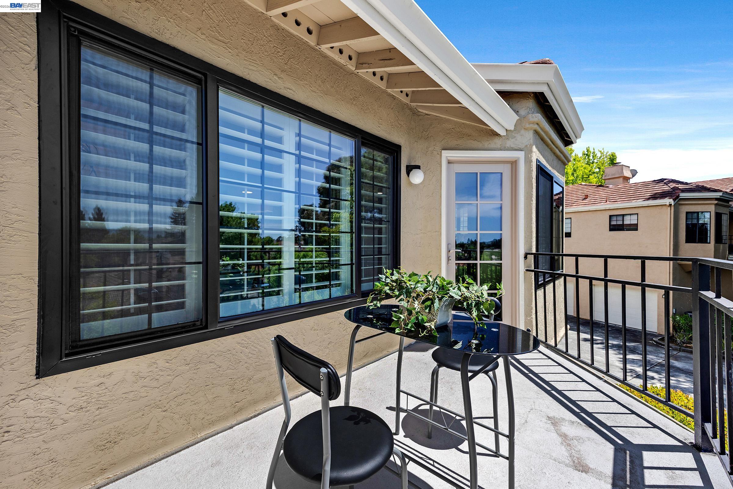 5012 Lakeview Drive, Unit 200 San Ramon, CA 94582 - Photo 31 of 47 a balcony with table and chairs potted plants with wooden floor