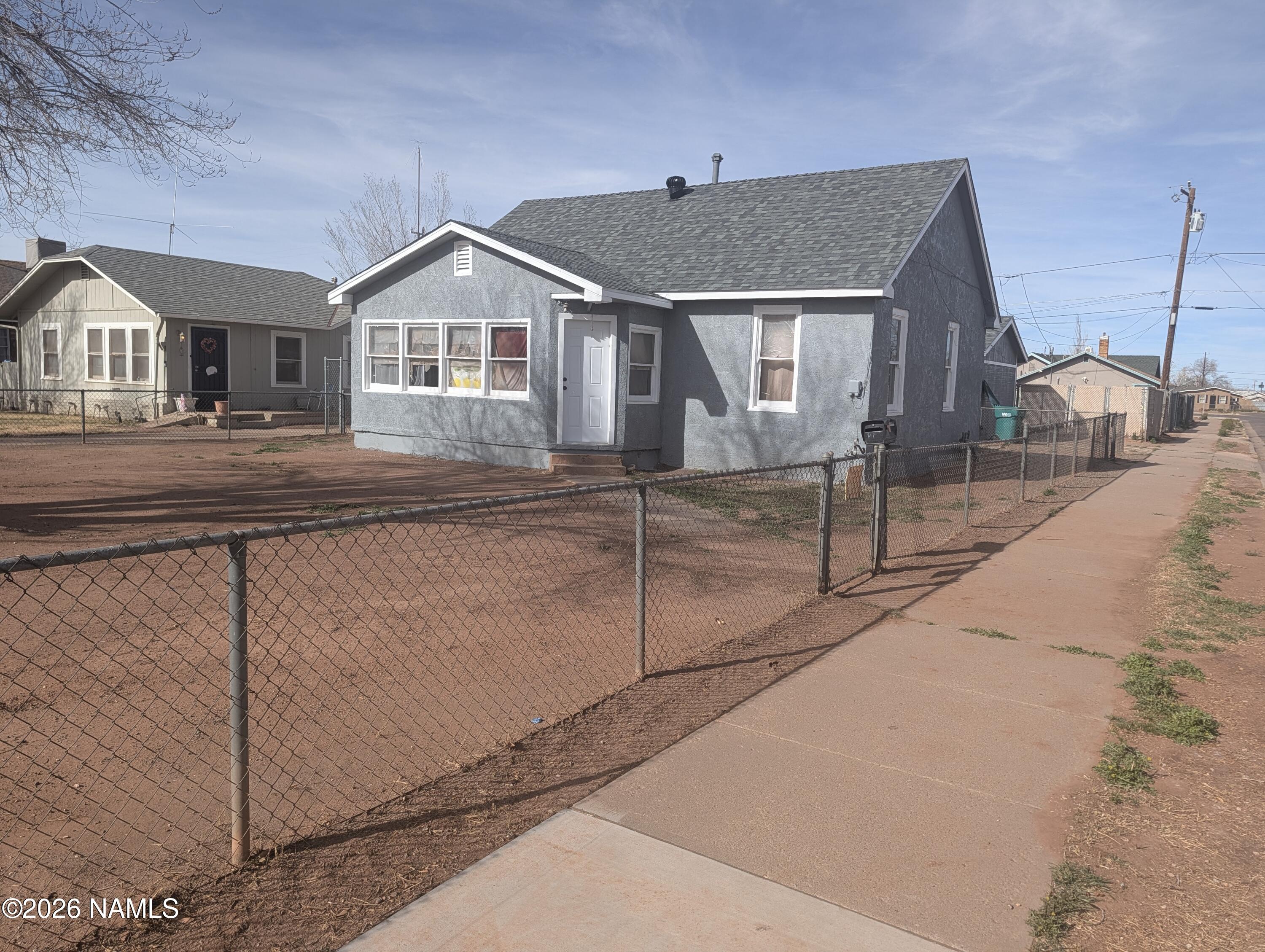 700 West Maple Street Winslow, AZ 86047 - Photo 2 of 15 a front view of a house with a yard