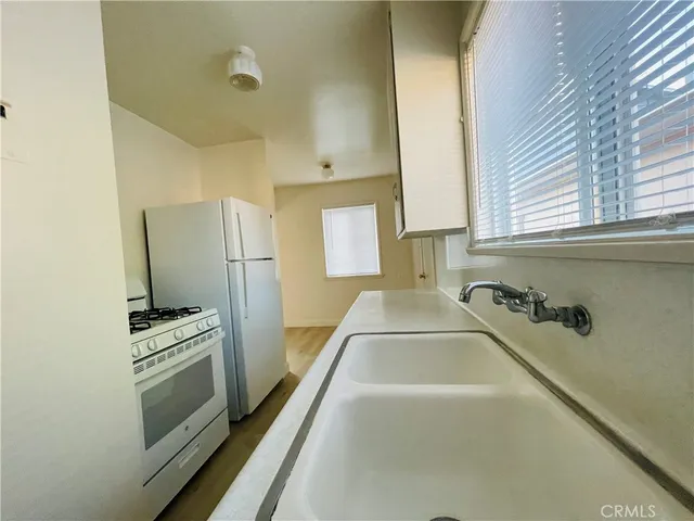 a kitchen with a refrigerator and a stove