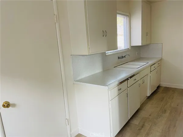 a utility room with cabinets washer and dryer