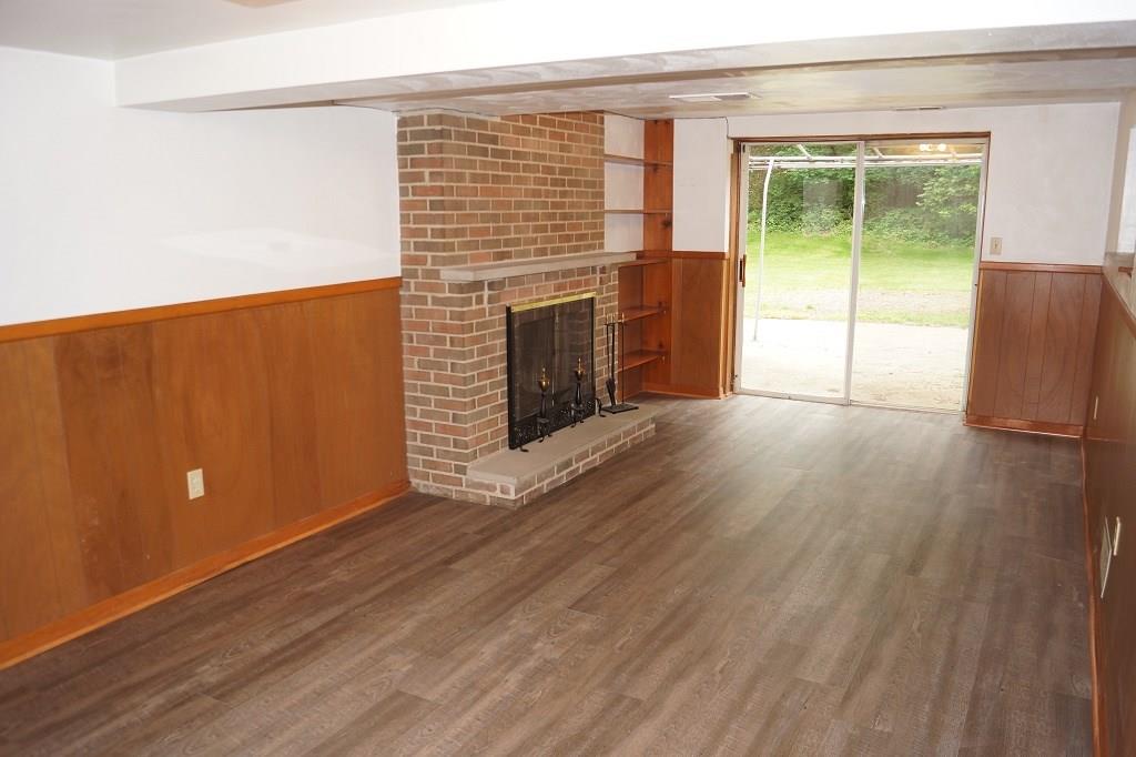 121 Kingsdale Road Pittsburgh, PA 15221 - Photo 20 of 25 Large basement area with wood burning fireplace and access to the back patio.