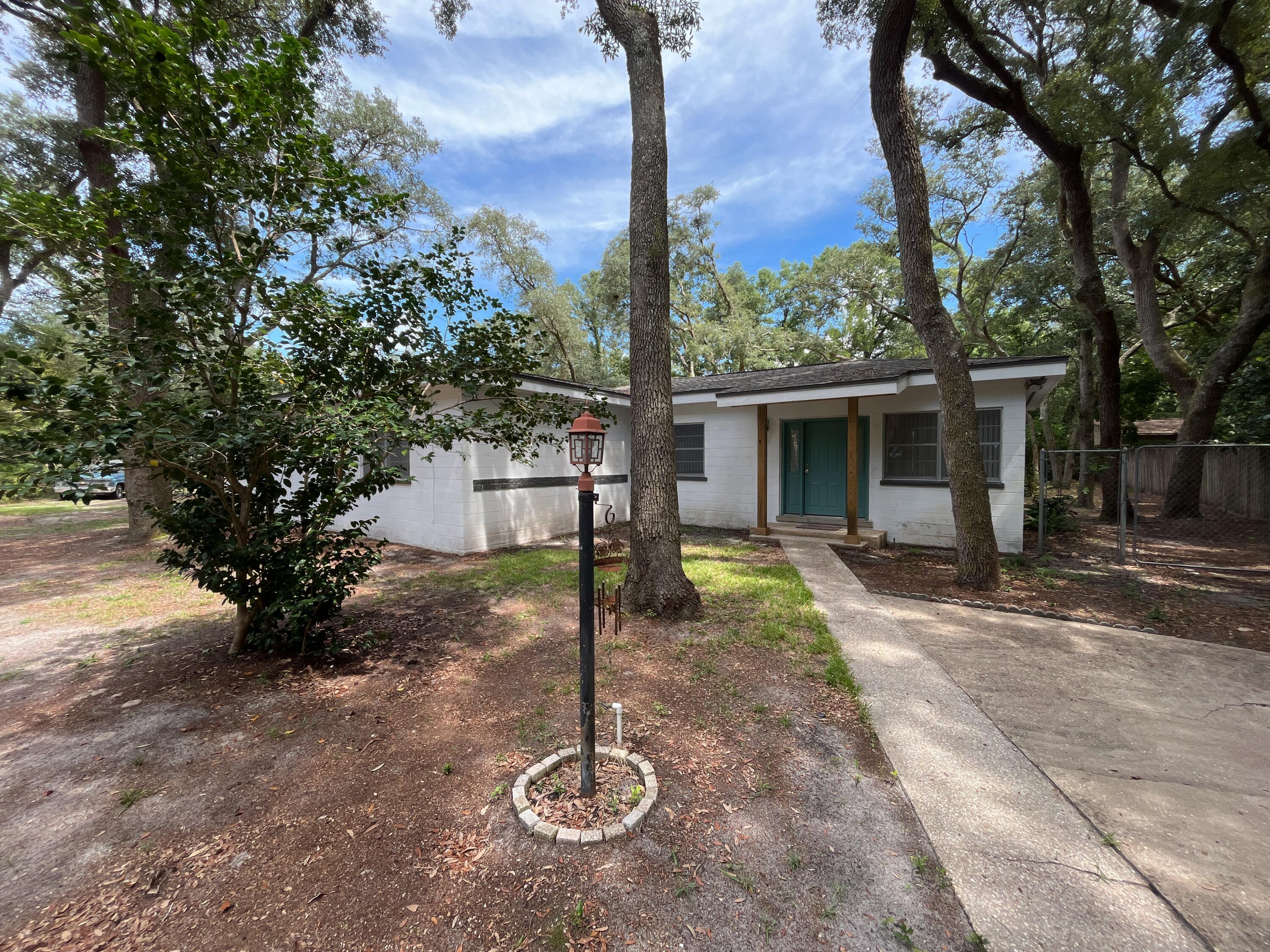 a front view of a house with a yard garage and outdoor seating