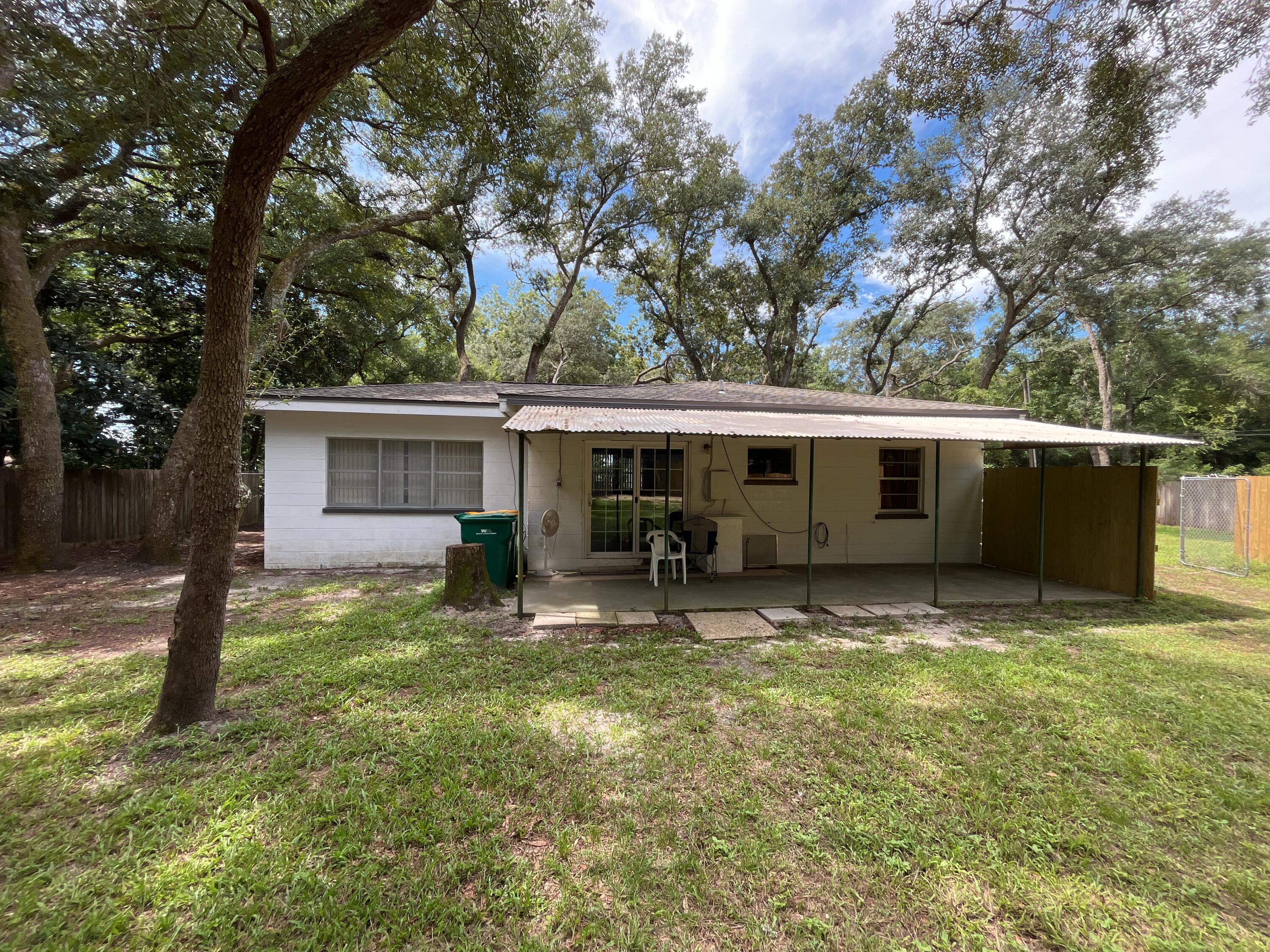 44 Meigs Drive Shalimar, FL 32579 - Photo 14 of 14 a backyard of a house with yard fire pit and outdoor seating