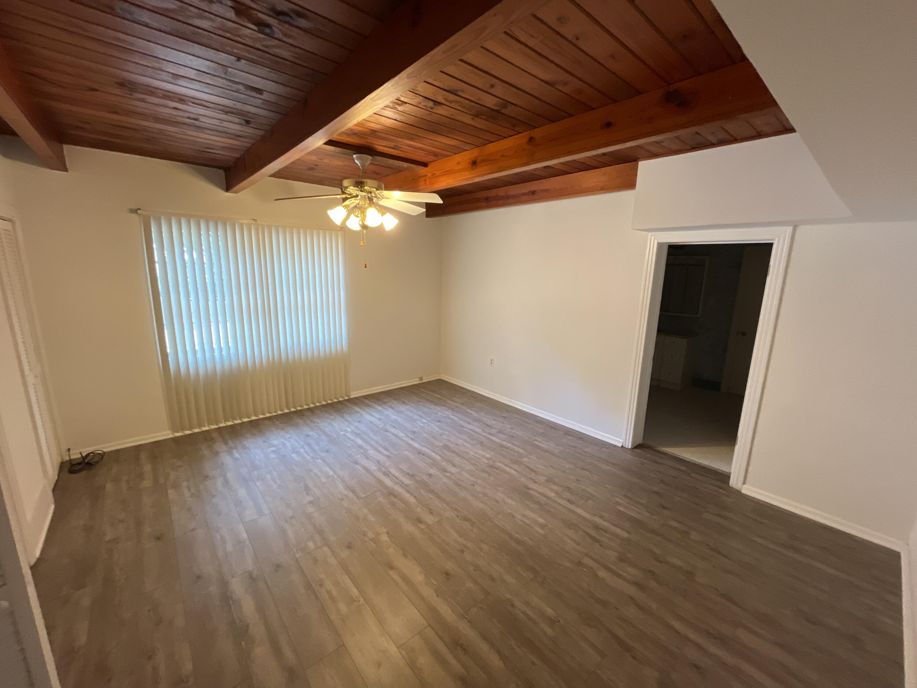 44 Meigs Drive Shalimar, FL 32579 - Photo 3 of 14 an empty room with wooden floor and windows