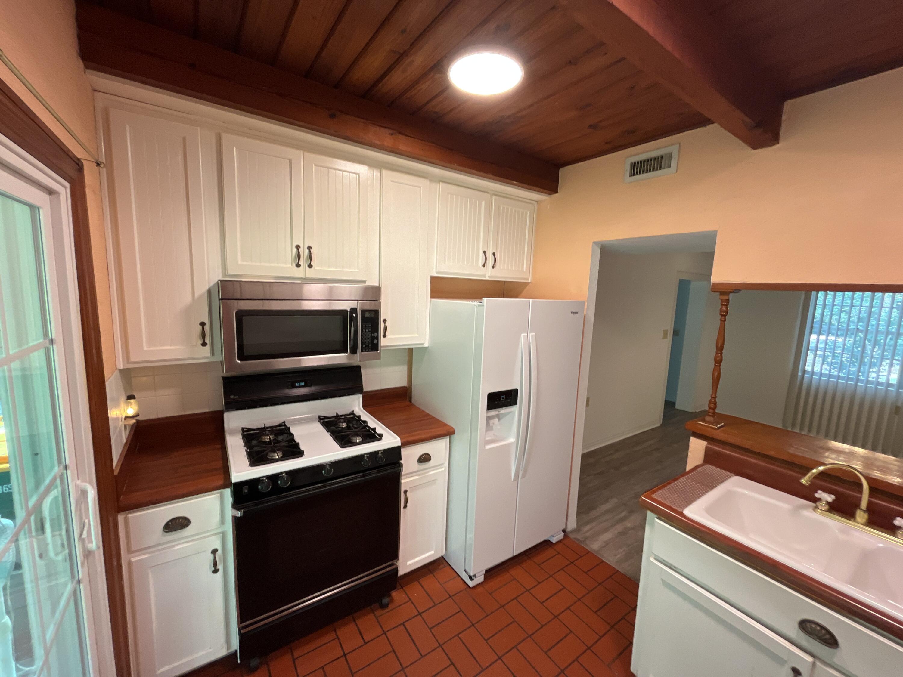 44 Meigs Drive Shalimar, FL 32579 - Photo 4 of 14 a kitchen with stainless steel appliances a refrigerator stove and sink