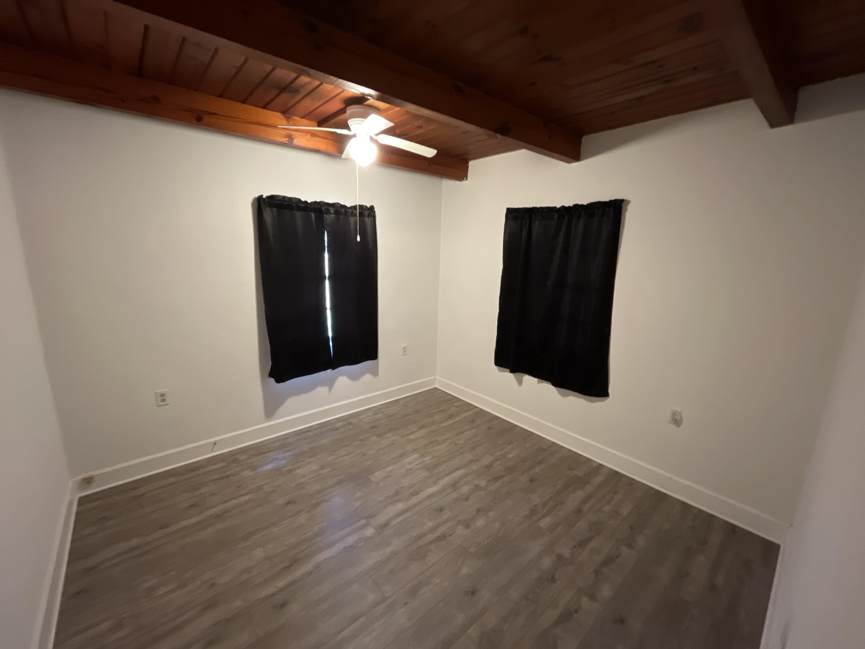 44 Meigs Drive Shalimar, FL 32579 - Photo 8 of 14 a view of an empty room with wooden floor