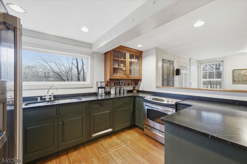17 Old River Road Milford, NJ 08848 - Photo 15 of 46 a kitchen with stainless steel appliances granite countertop a sink stove and cabinets