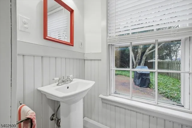 a bathroom with a sink and a window