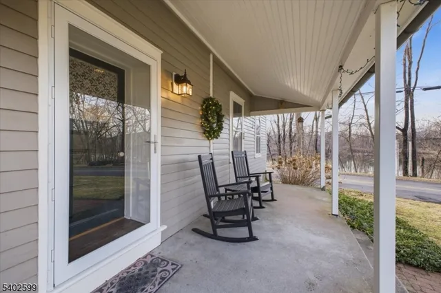 a view of a chairs and table in the balcony
