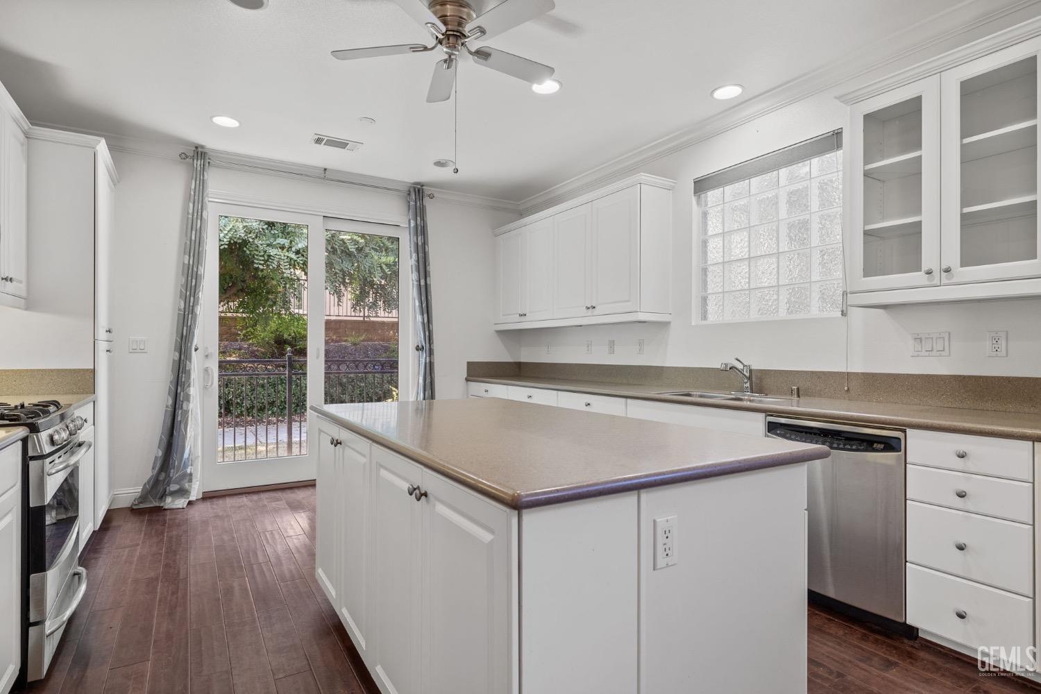 Undisclosed Address Bakersfield, CA 93306 - Photo 11 of 54 a kitchen with a stove a sink and a refrigerator