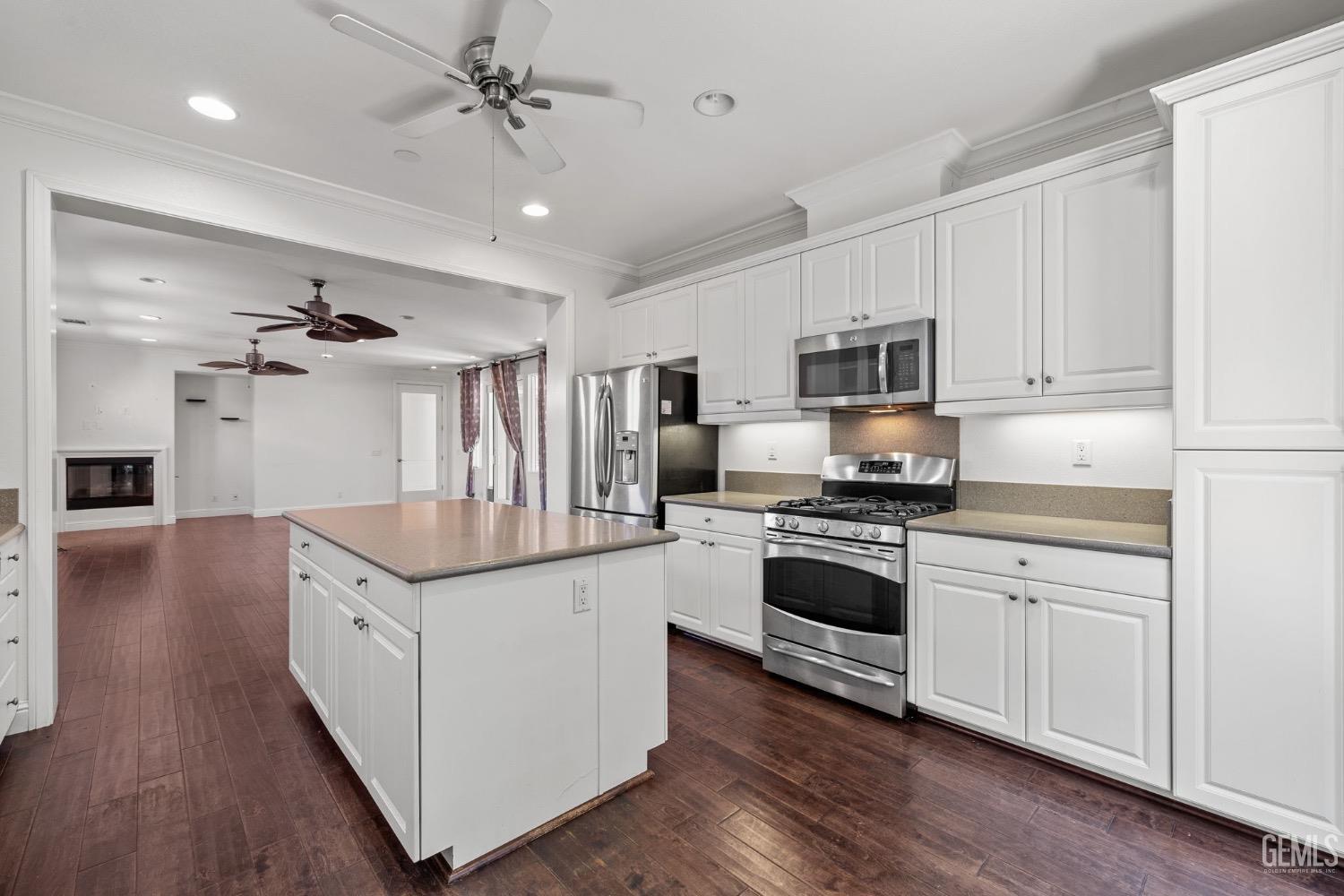 Undisclosed Address Bakersfield, CA 93306 - Photo 12 of 54 a kitchen with stainless steel appliances granite countertop a kitchen island hardwood floor sink stove and granite counter top