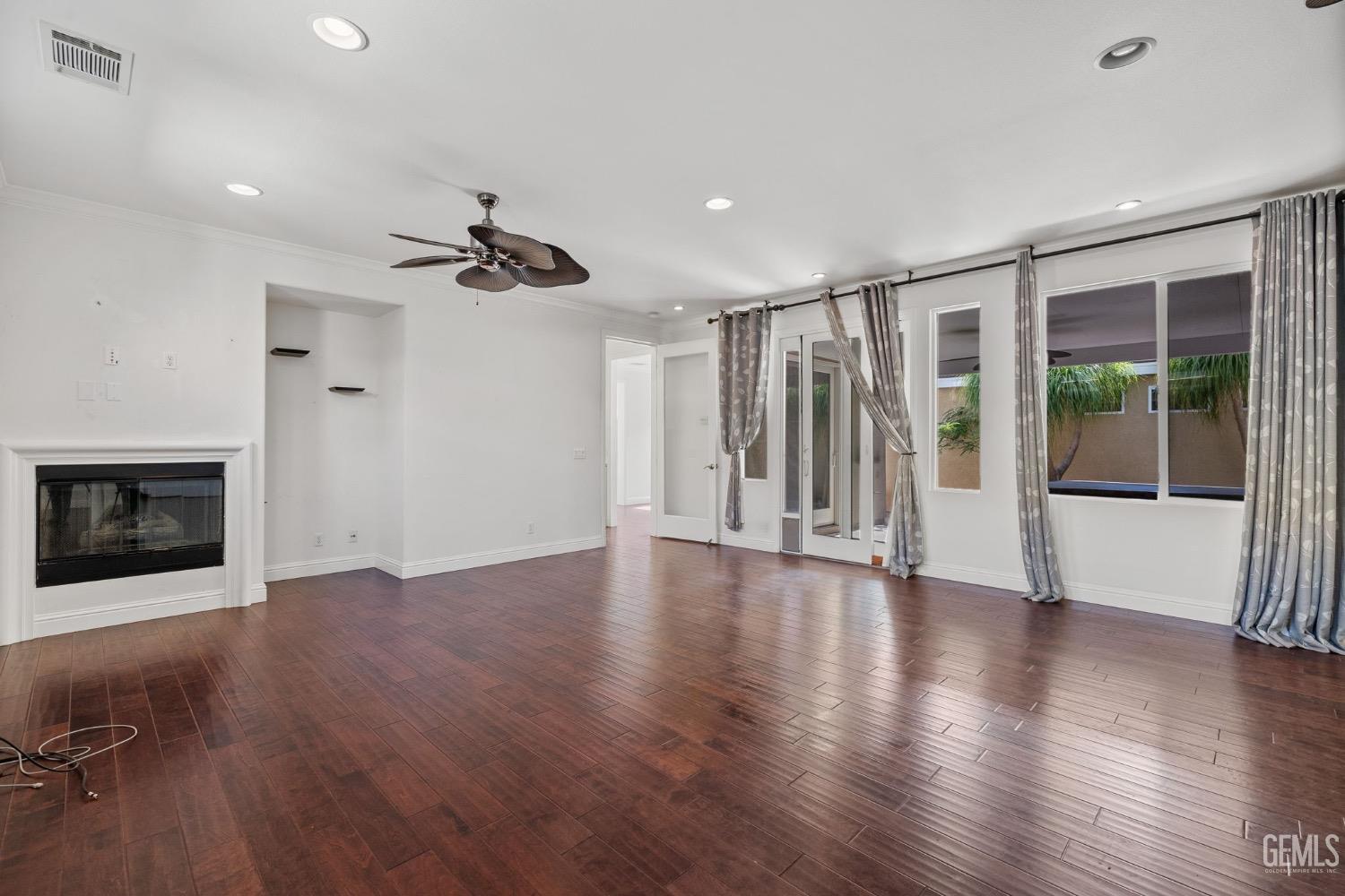 Undisclosed Address Bakersfield, CA 93306 - Photo 15 of 54 a view of an empty room with a window and wooden floor