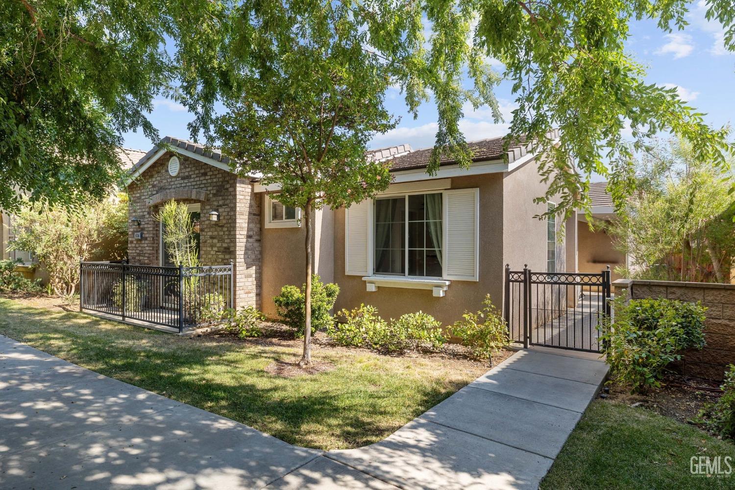Undisclosed Address Bakersfield, CA 93306 - Photo 2 of 54 a front view of a house with garden