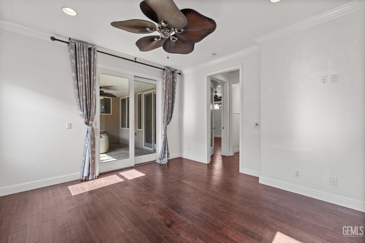 Undisclosed Address Bakersfield, CA 93306 - Photo 23 of 54 a view of an empty room with wooden floor and a ceiling fan