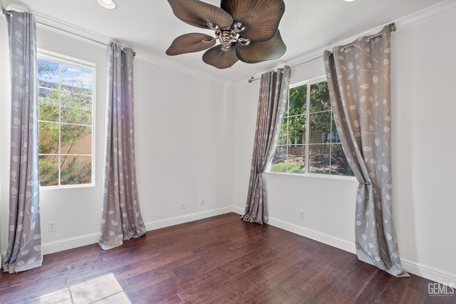 Undisclosed Address Bakersfield, CA 93306 - Photo 29 of 54 a view of an empty room with wooden floor and windows