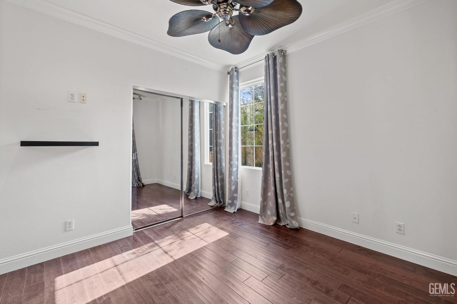 Undisclosed Address Bakersfield, CA 93306 - Photo 31 of 54 an empty room with wooden floor and windows