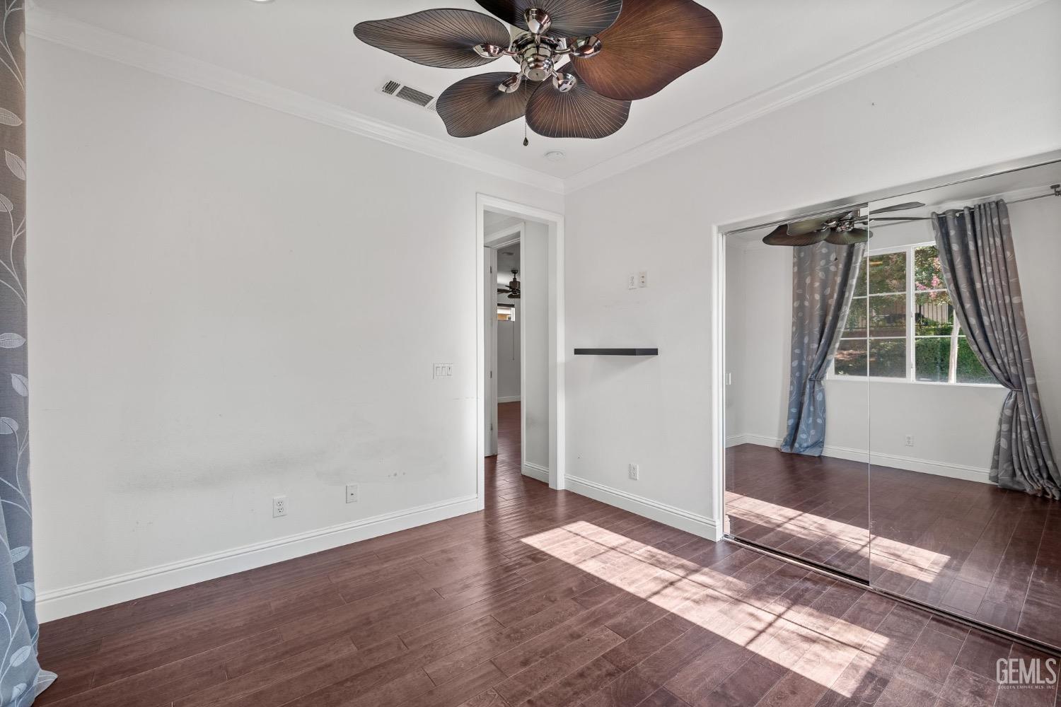 Undisclosed Address Bakersfield, CA 93306 - Photo 32 of 54 a view of an empty room with wooden floor and a window