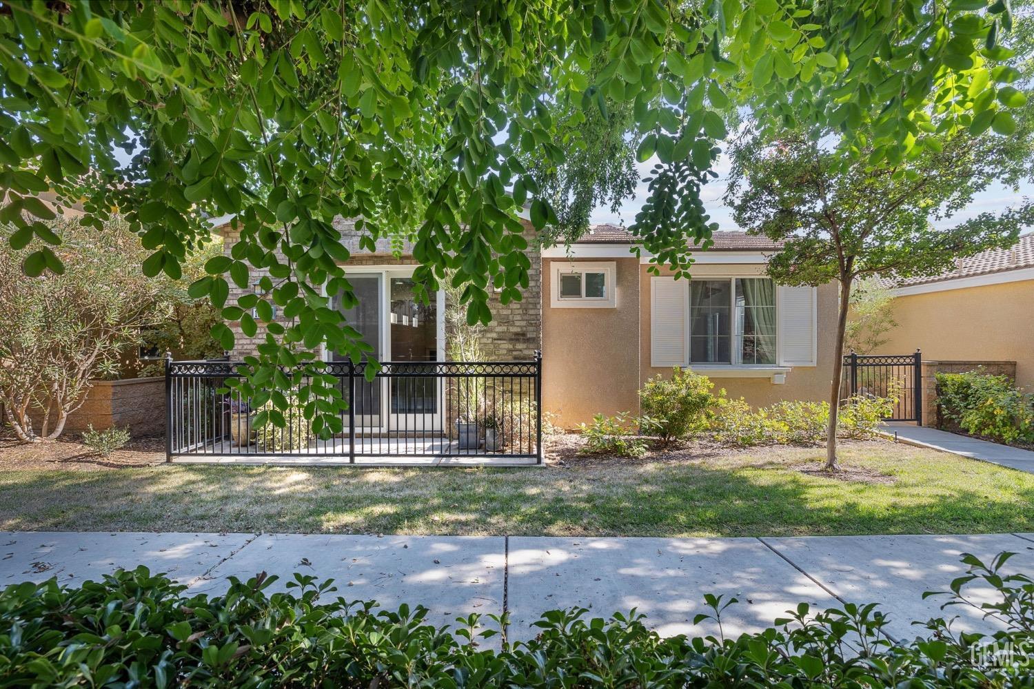 Undisclosed Address Bakersfield, CA 93306 - Photo 4 of 54 a front view of a house with a yard
