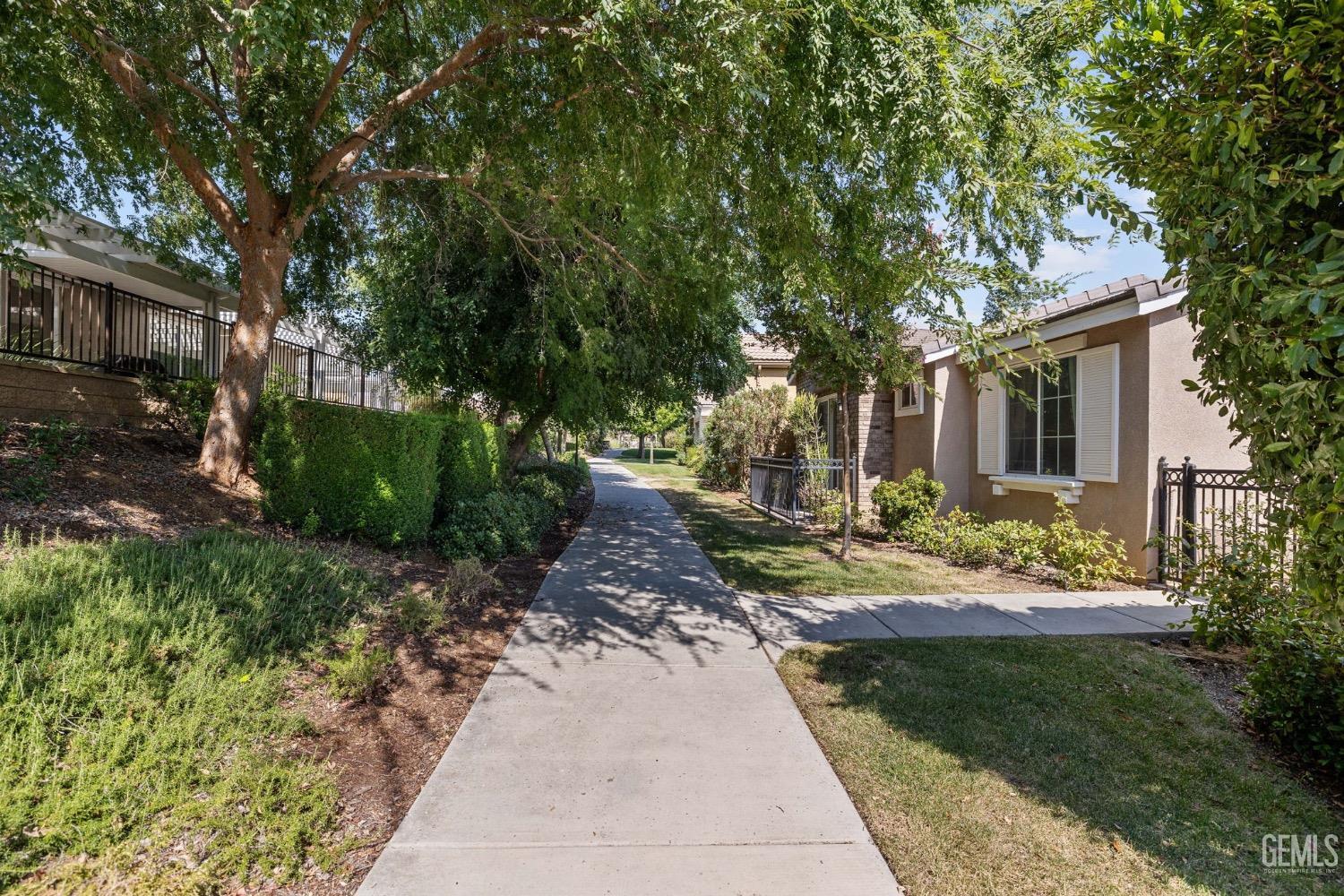 Undisclosed Address Bakersfield, CA 93306 - Photo 5 of 54 a front view of a house with garden