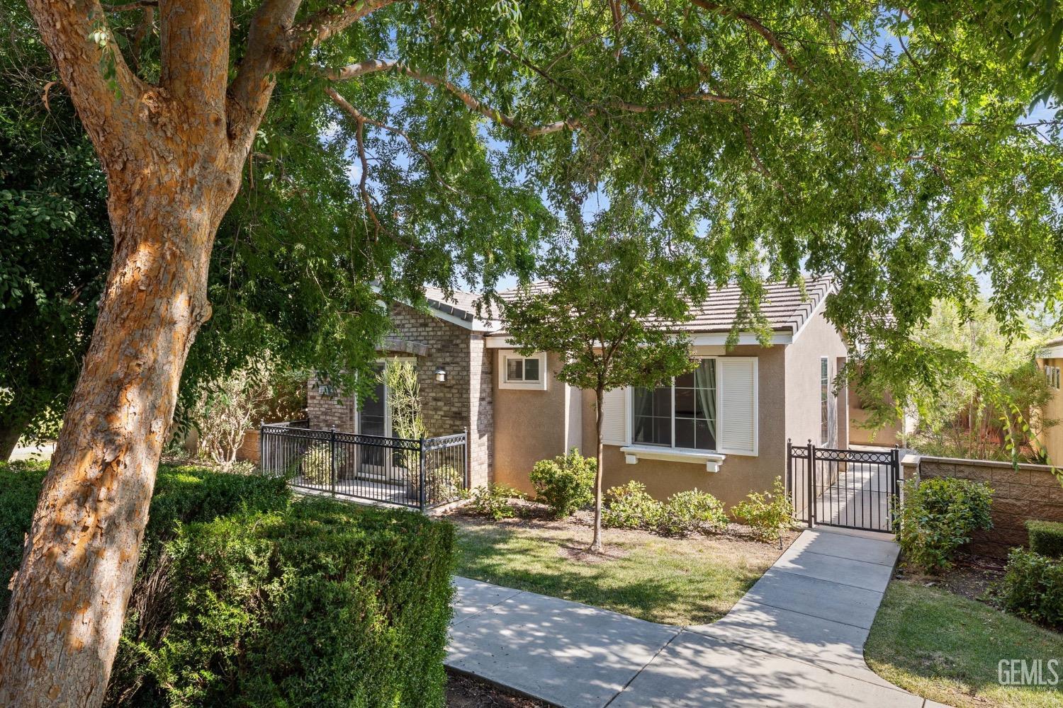 Undisclosed Address Bakersfield, CA 93306 - Photo 6 of 54 a front view of a house with garden and patio