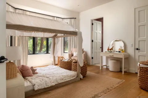 a living room with furniture and a floor to ceiling window