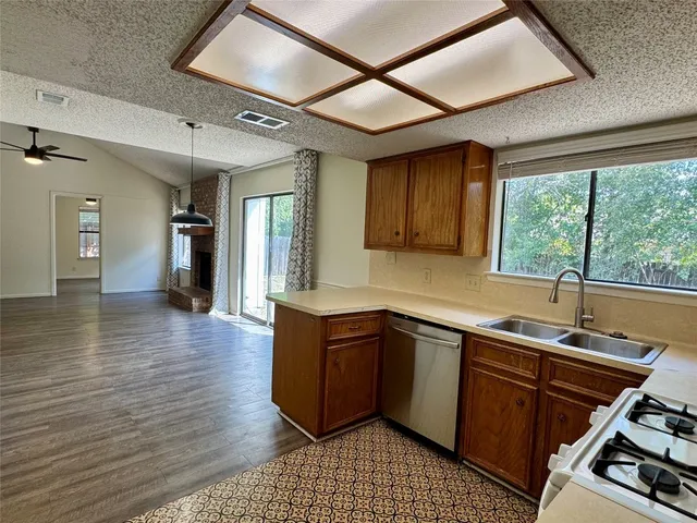 a kitchen with a sink and wooden cabinets