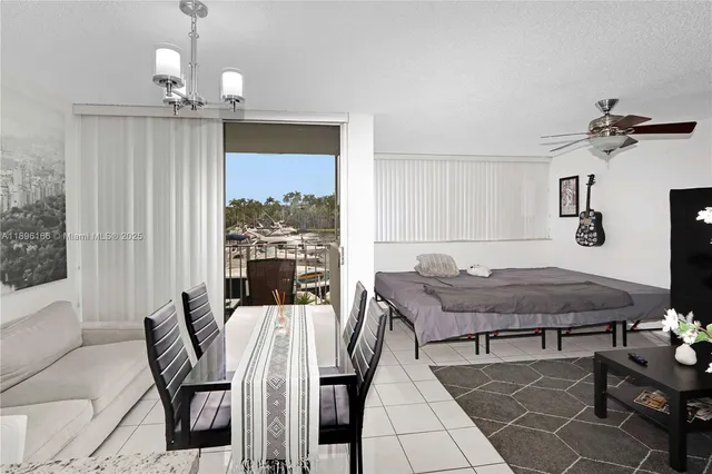 a dining room with wooden floor a chandelier a wooden table and chairs