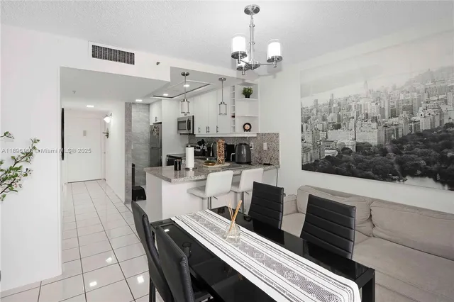 a view of a dining room with furniture wooden floor and chandelier
